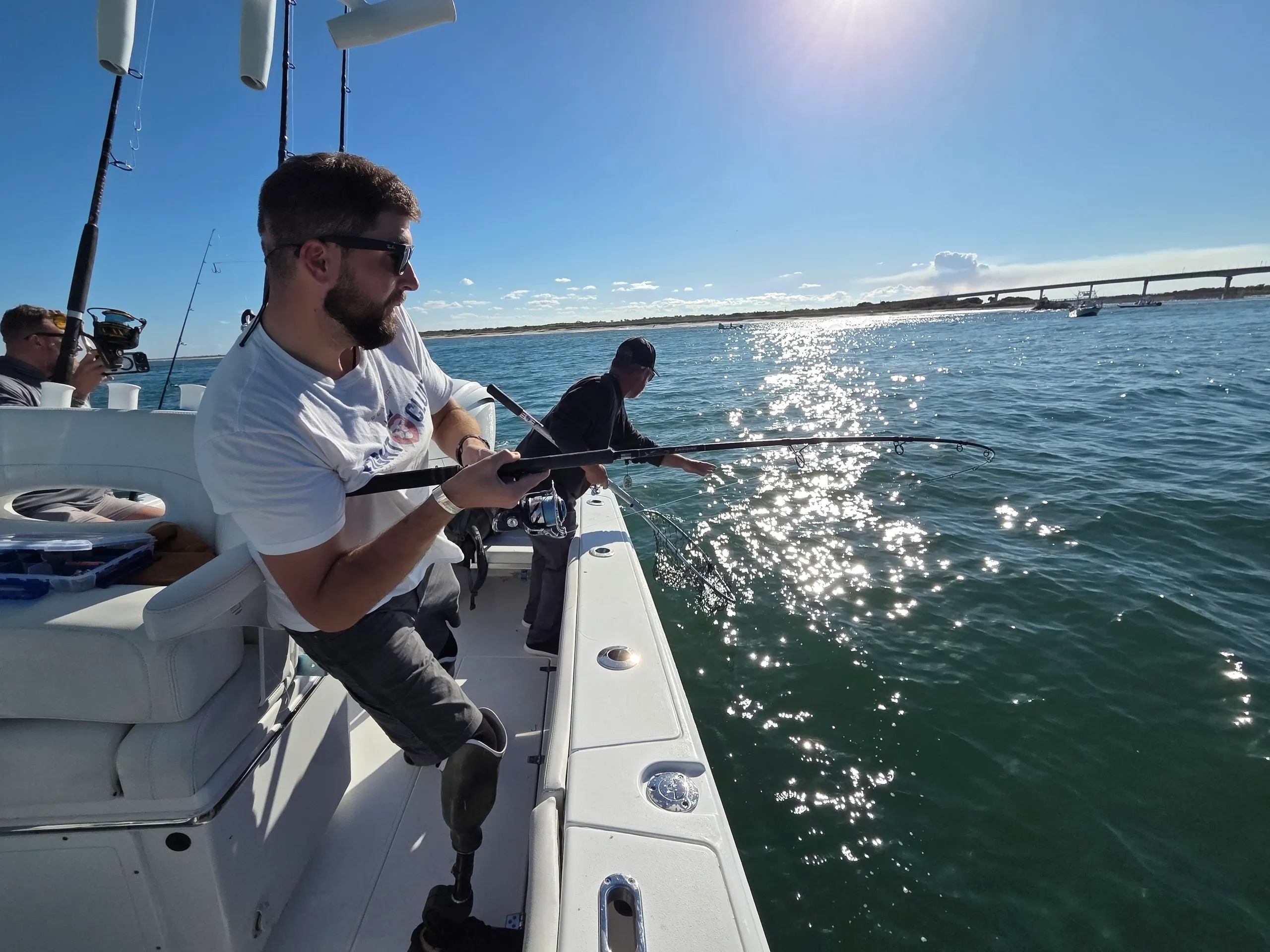 Anglers with rods on sunny day