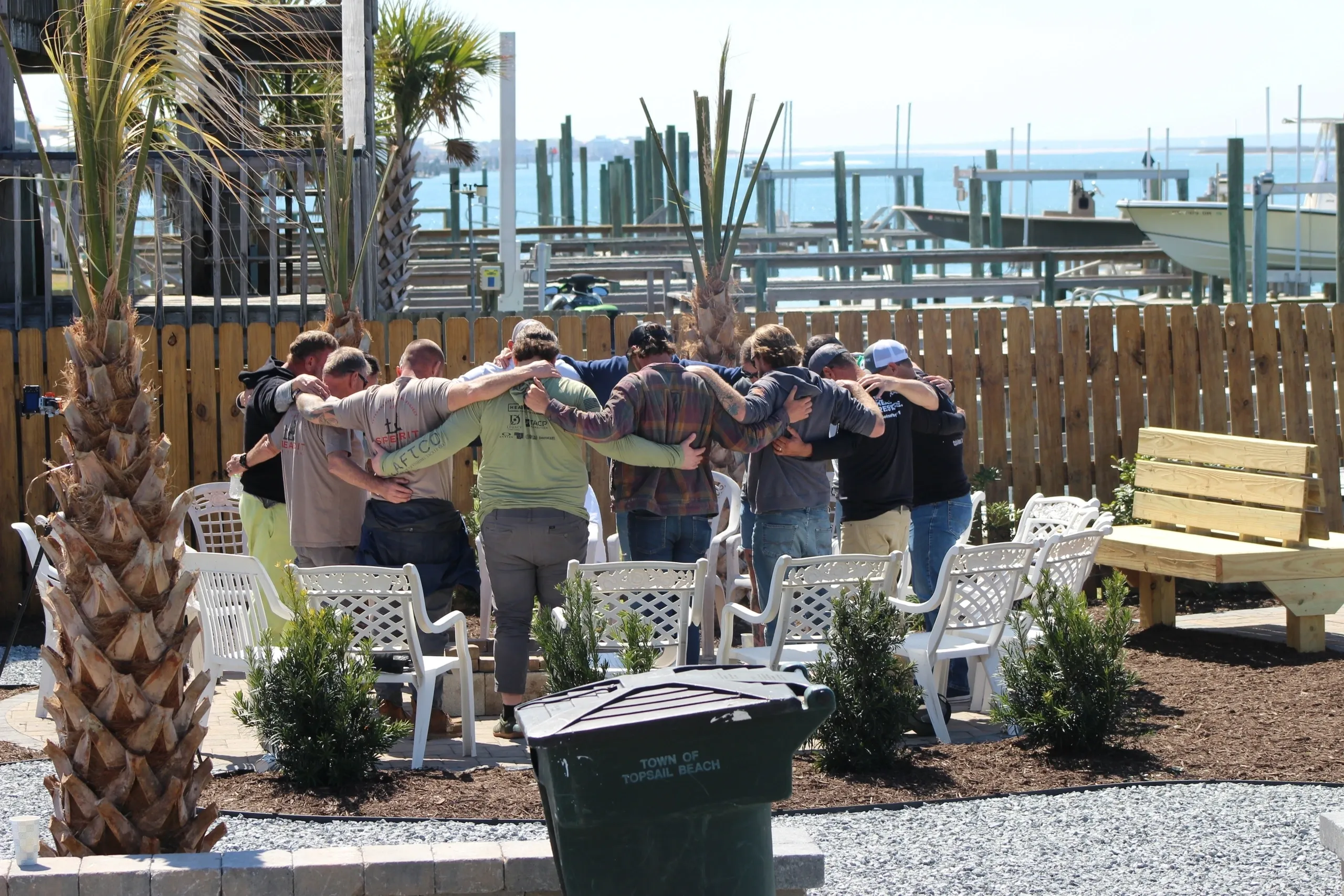 Gathering near a marina with palm trees