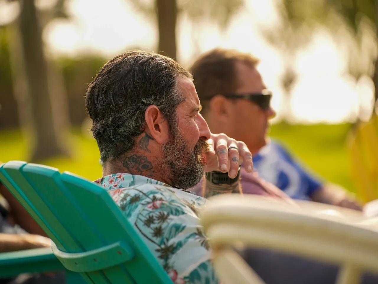 Tattooed man in sunny outdoor setting