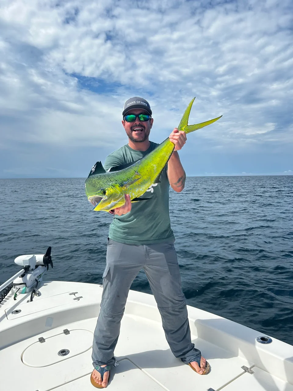 Man holding a large fish on boat